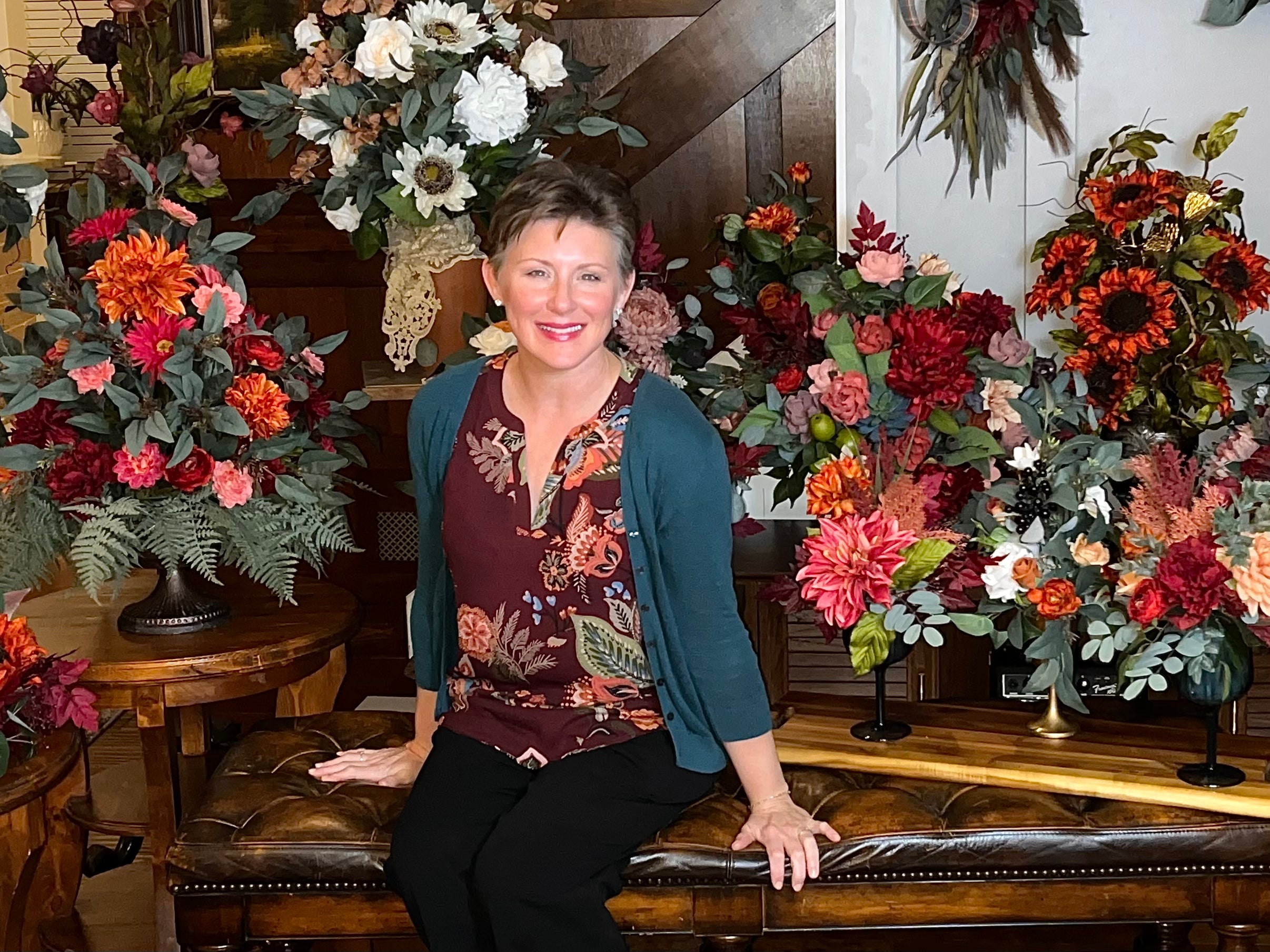 Melody Fuller, floral designer and founder of Ivory Road Floral, with dried and silk arrangements